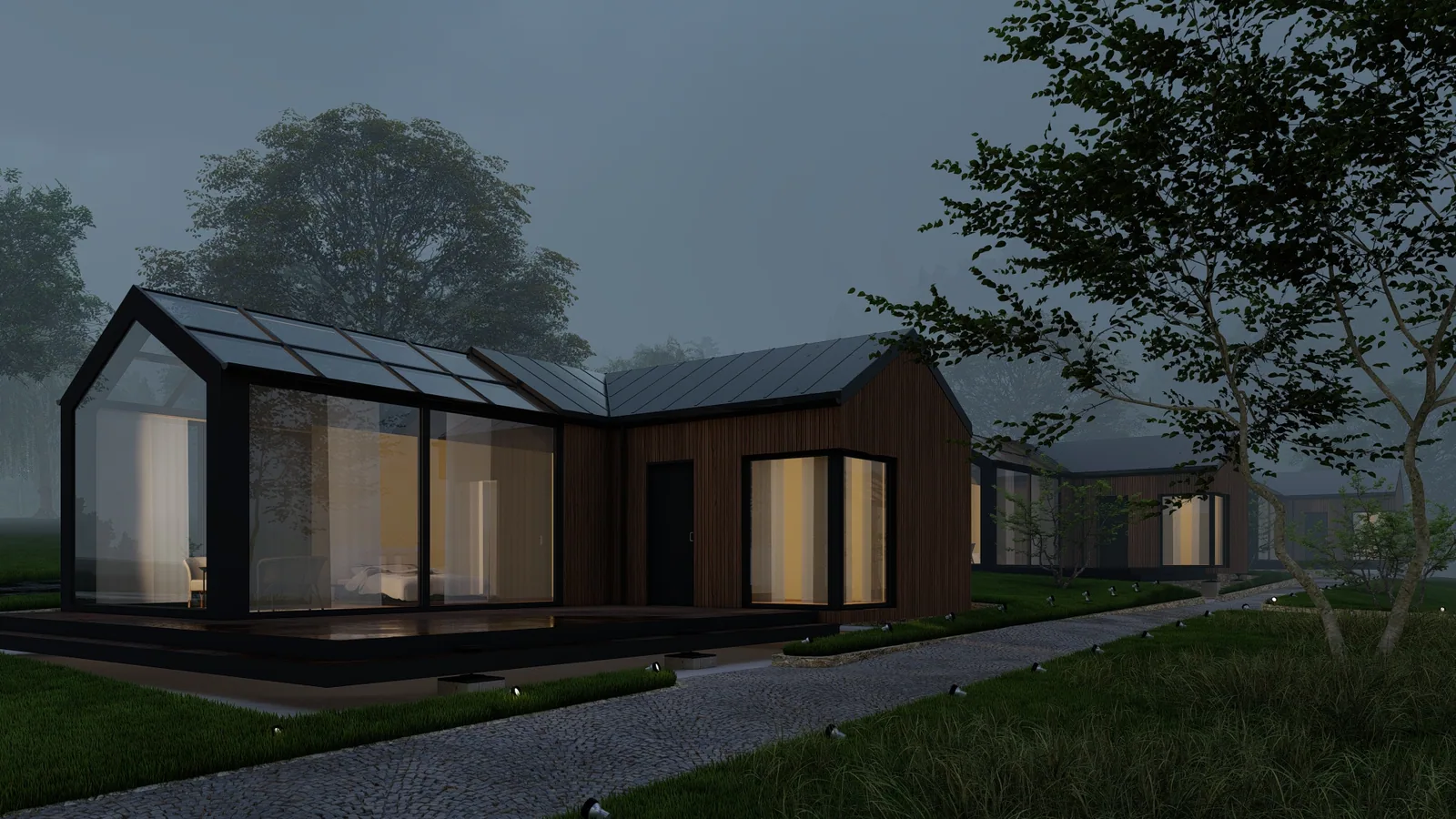 Mehrere Tiny Houses mit Satteldach und Holzfassade in der Abenddämmerung