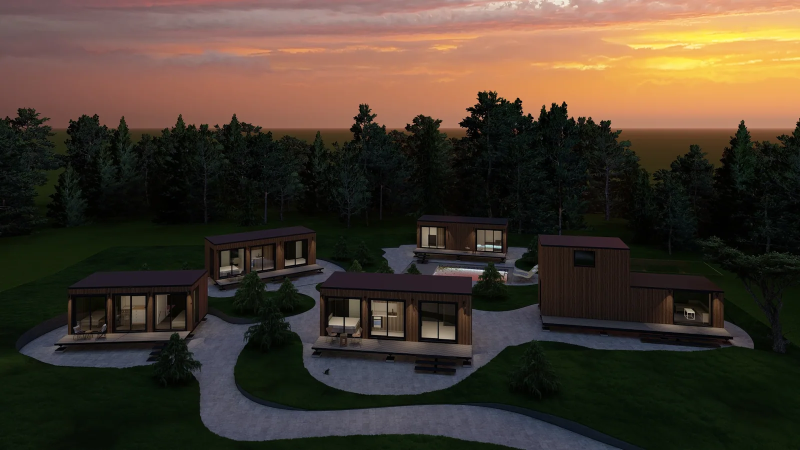 Gruppe von Tiny Houses an einem Hang, abends beleuchtet, mit Wegen dazwischen